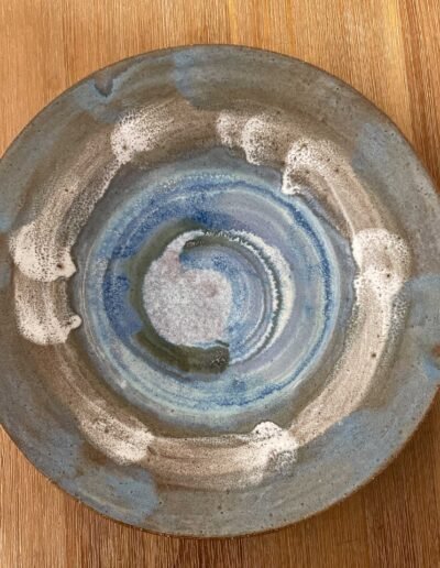 Shallow ceramic dish with mottled blue, lavender and grey glaze