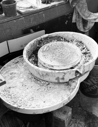 Pottery wheel caked in dried clay and trimmings, in black and white