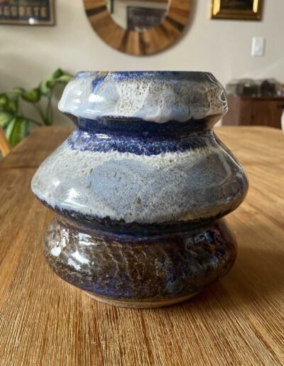 Tiered stoneware vase with dripping white, blue and brown glazes