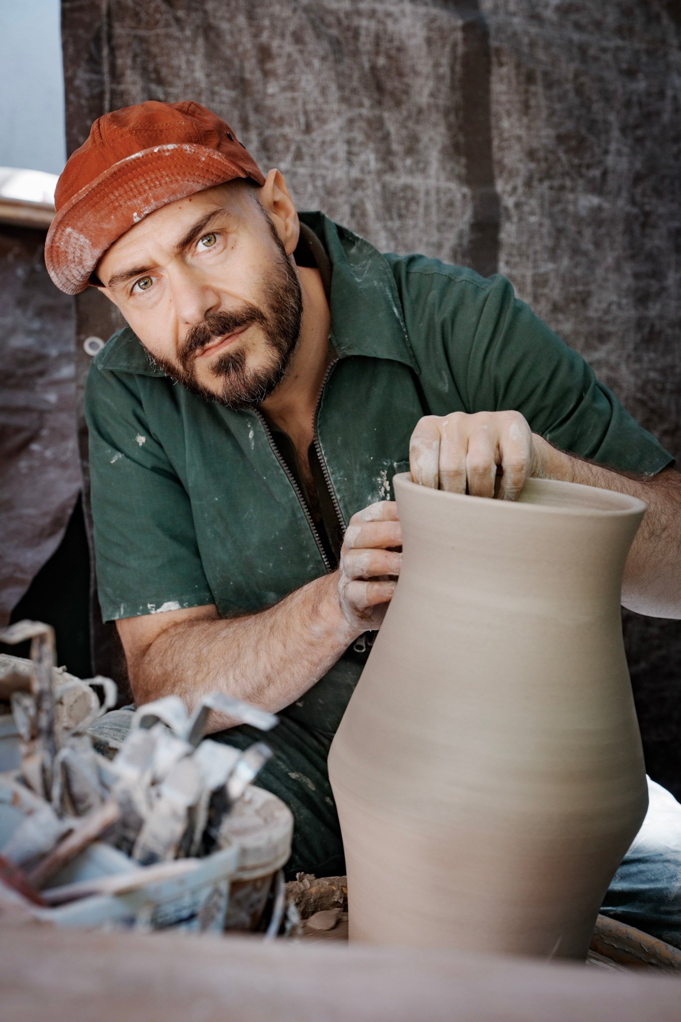 Ceramics Alessio di Giambattista shaping a clay pot on an outdoor pottery wheel